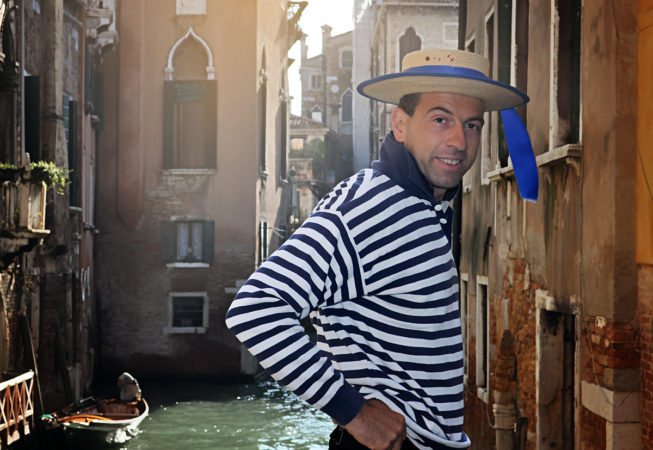 'Gondolier In Venice Italy' by Photographer Debbi Nelson. © Copyright 2016 Debbi Nelson dba Photograzia